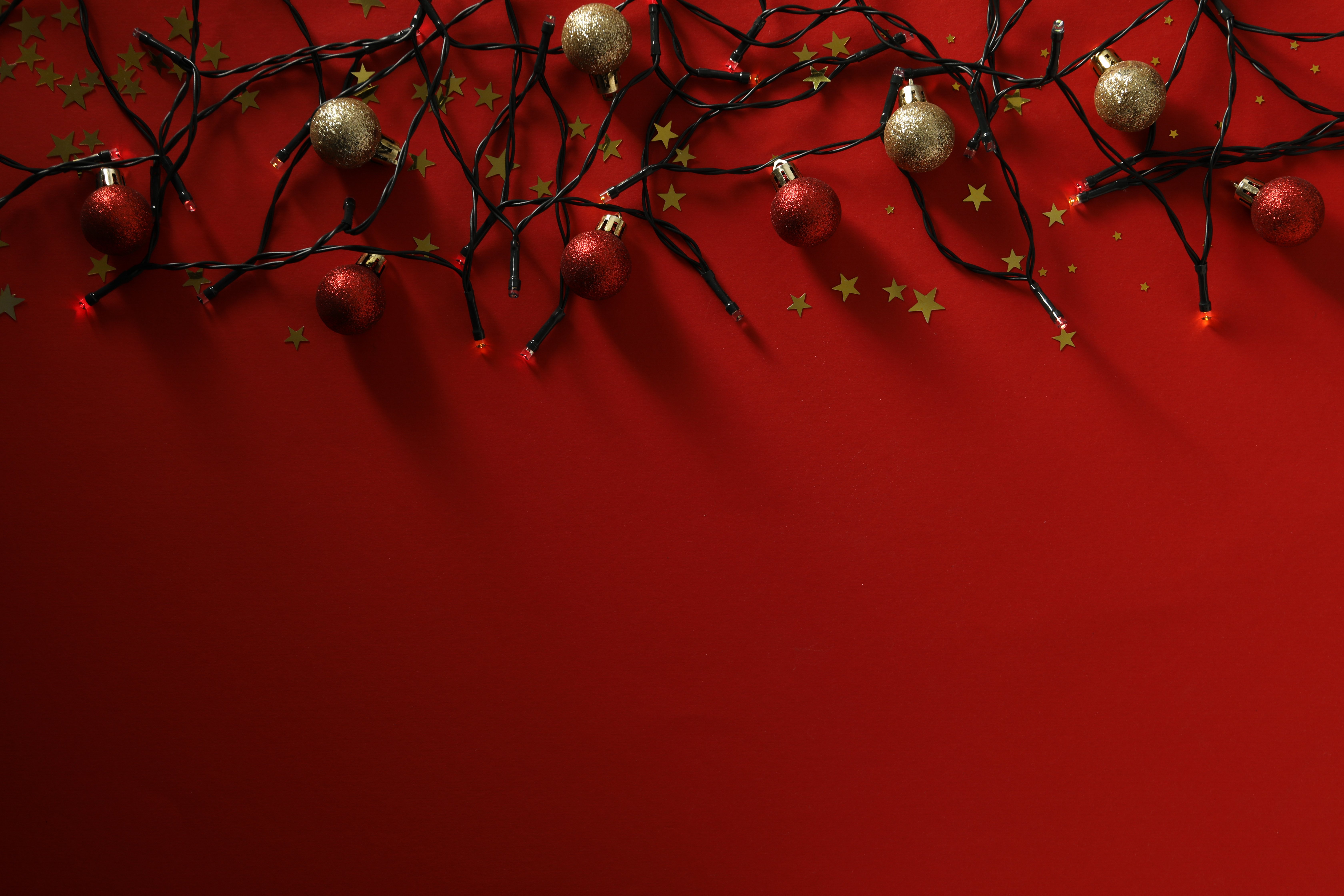 christmas-lights-and-balls-on-red-background-spac-2025-03-26-12-57-22-utc